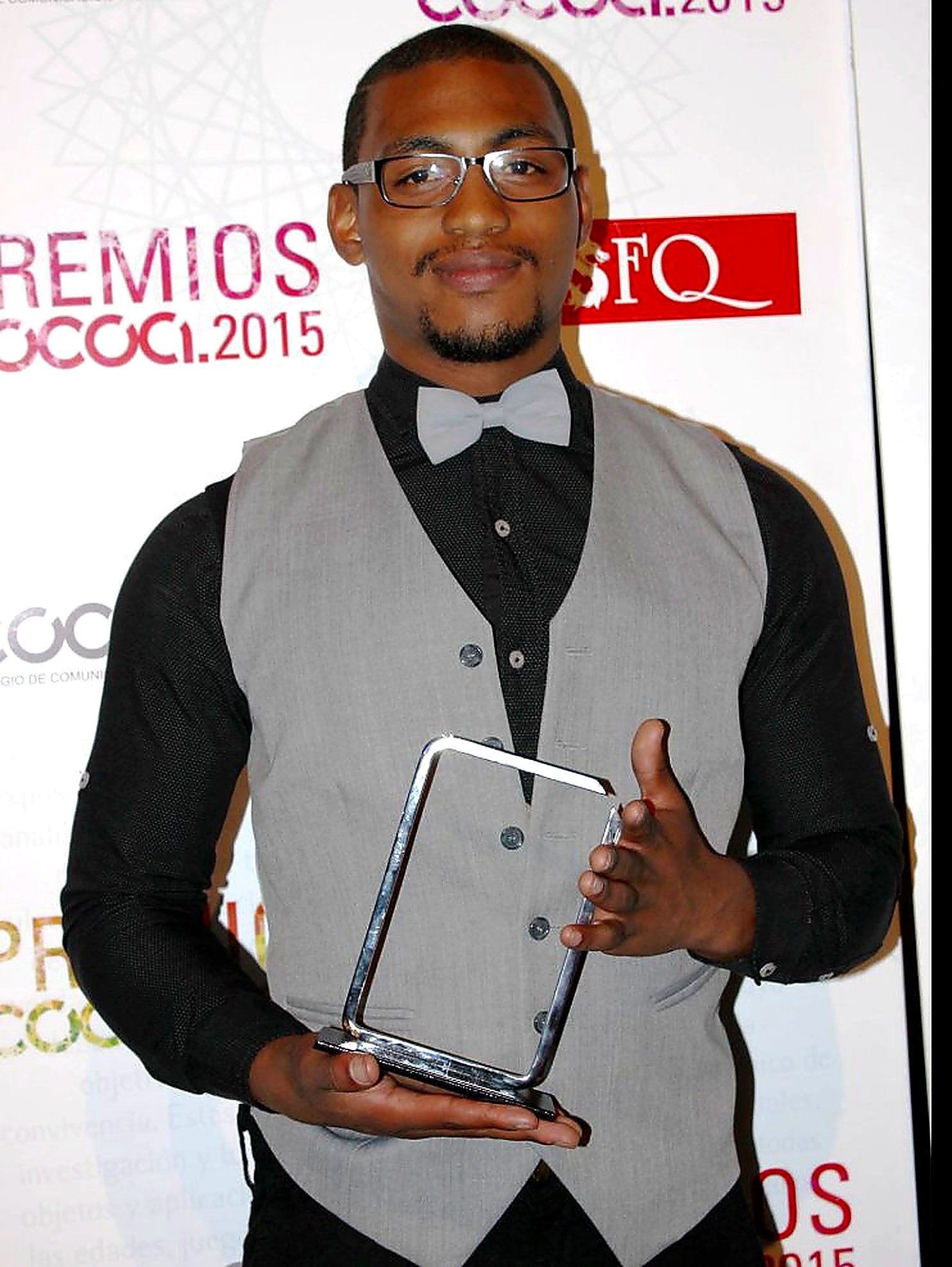 Eddy Perlaza holding COCOA 2015 award trophy USFQ ceremony
