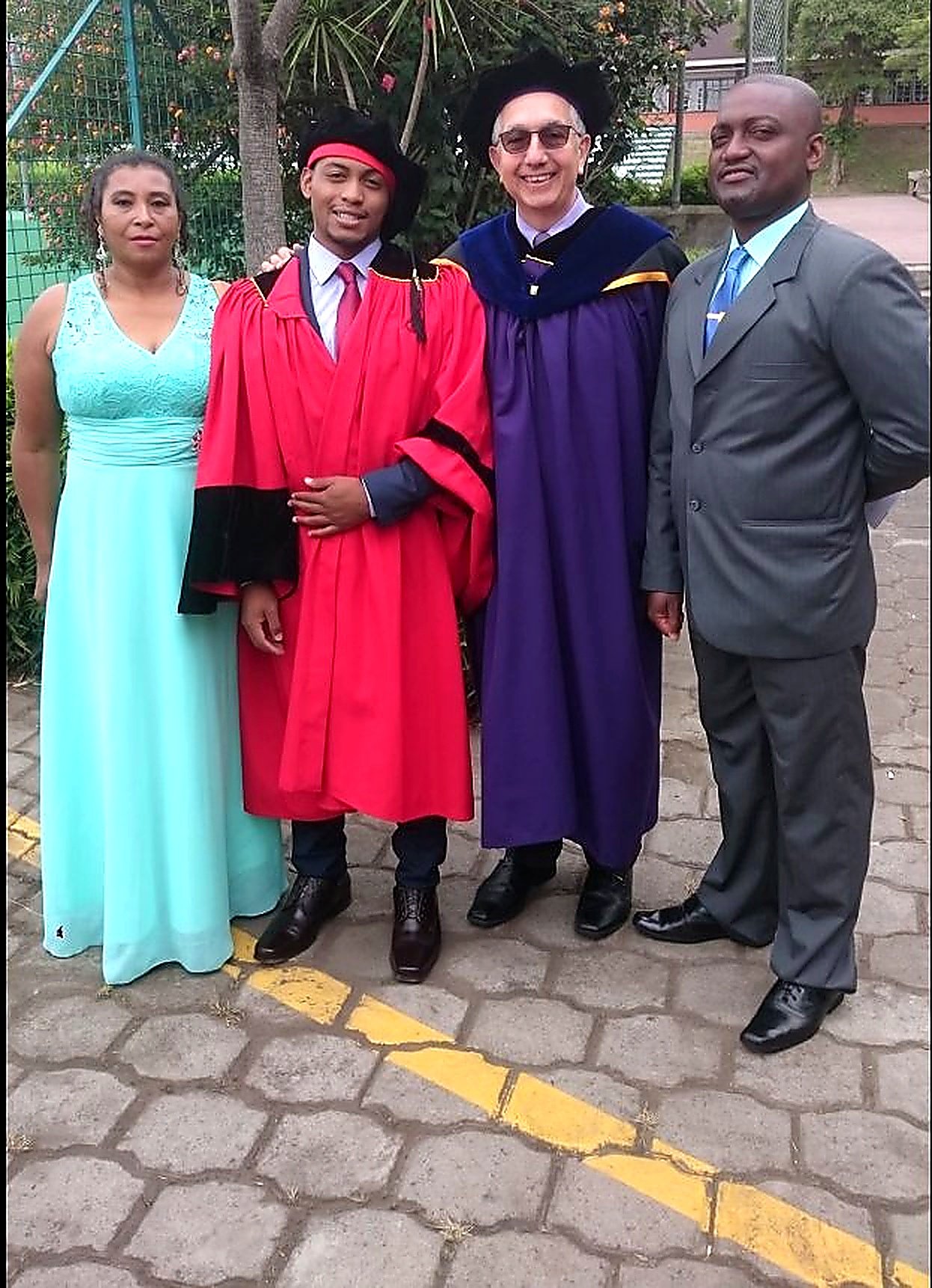 Eddy Perlaza graduating USFQ red robes family professor
