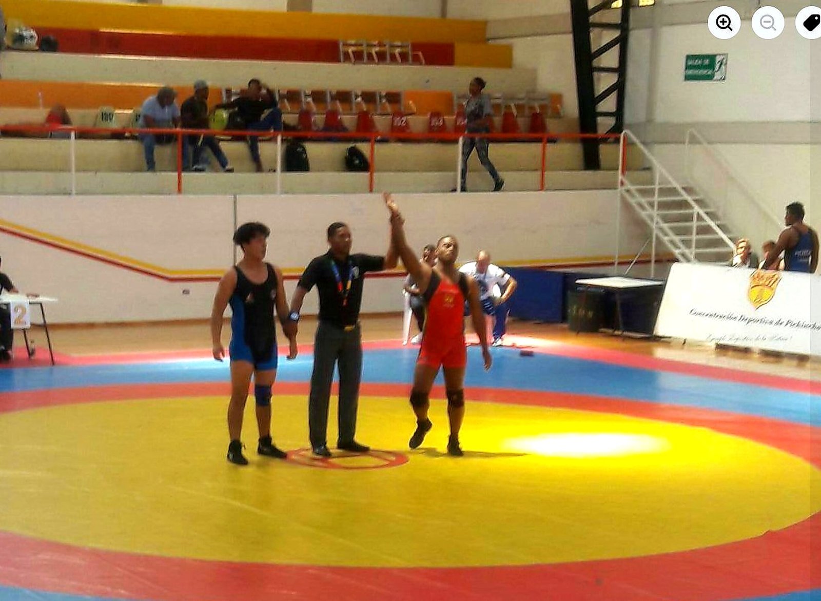 Eddy Perlaza winning national wrestling championship arm raised by referee Concentracion Deportiva de Pichincha