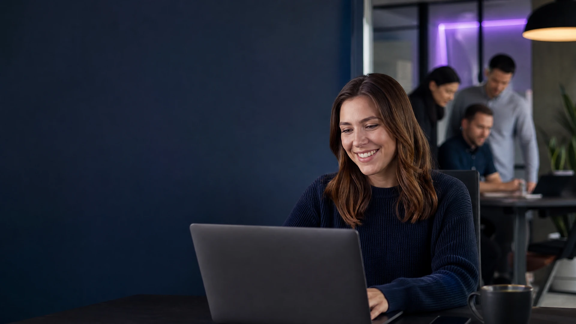 Customer-success professional working with a support team in an office.