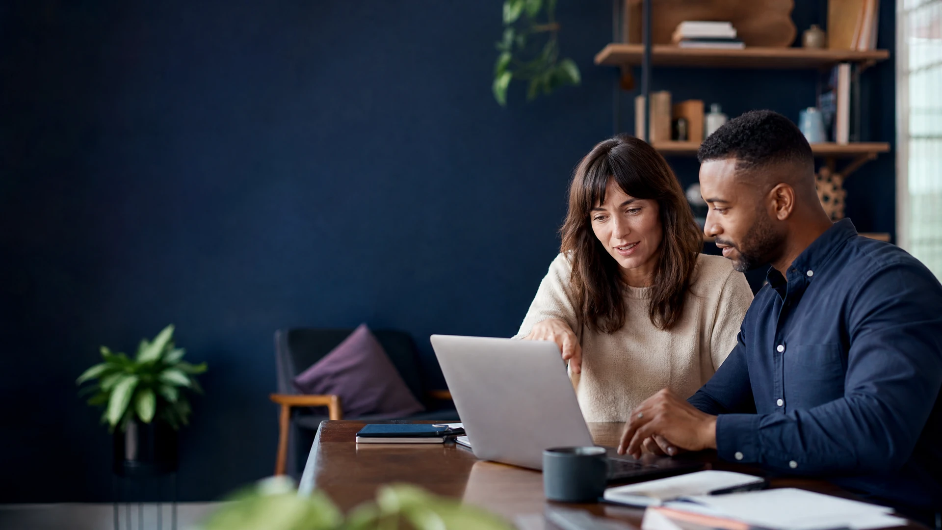 Founder and consultant reviewing a website content plan on a laptop.